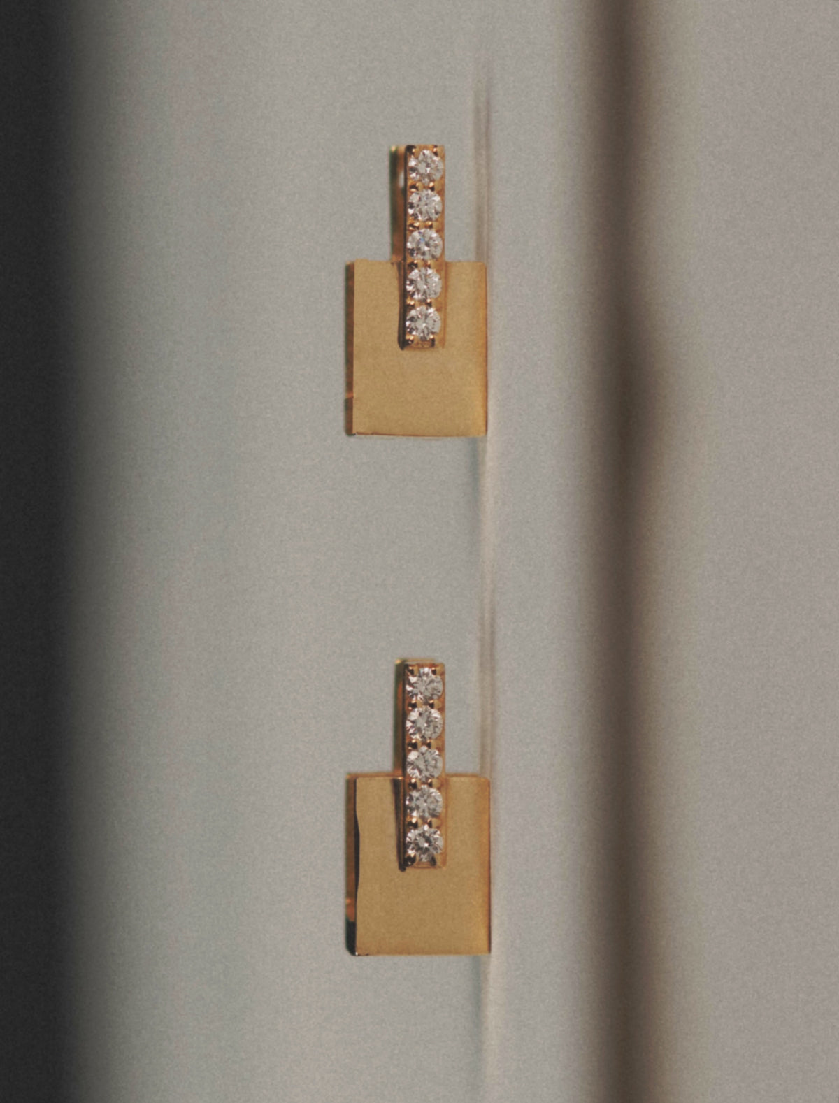 Pair of gold square-drop earrings with vertical rows of pavé diamonds